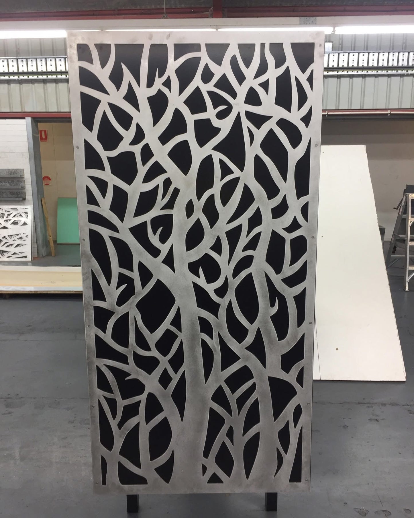 Galvanised steel privacy screen with laser-cut decorative pattern, providing outdoor privacy and a contemporary design feature for gardens and patios.